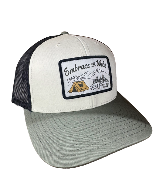 Little River Embrace the Wild 112 trucker hat with woven outdoor patch featuring mountains, trees, and a tent.