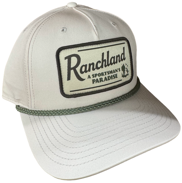 Khaki Ranchland 258 performance hat with Sportsman's Paradise patch and rope detail.