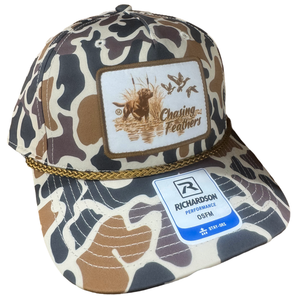 Chasing Feathers 258 Richardson performance hat in duck camo with gold rope and retriever hunting patch