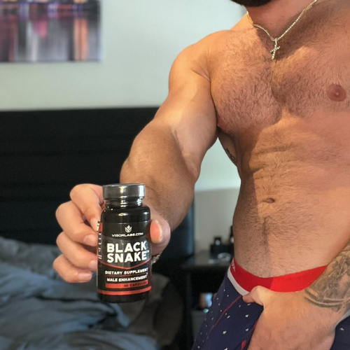 Man holding bottle of Black Snake