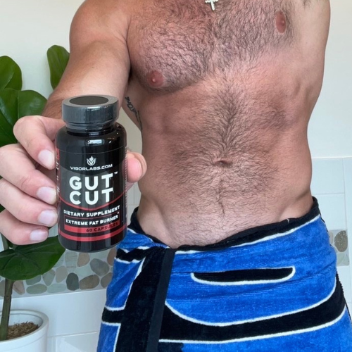 Man holding bottle of Gut Cut