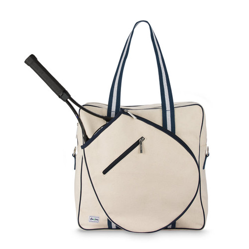 Front view of large canvas tennis tote with front pocket for tennis racquet. Tote has navy trim and handles.