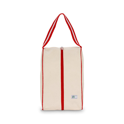 rectangular tan canvas shoe bag with red handles.