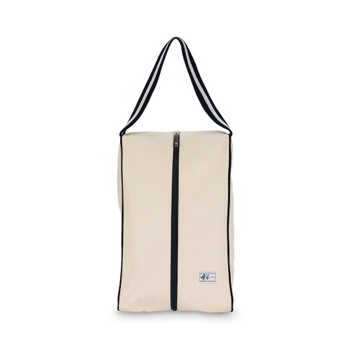rectangular tan canvas shoe bag with black handles.