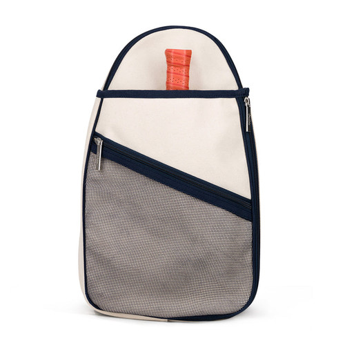 Front view of Hamptons pickleball sling bag. Bag has front mesh pocket and slip pocket on front to hold pickleball paddles. Bag has navy trim and navy and white striped straps. Bag has adjustable straps to be worn as a backpack or a crossbody.