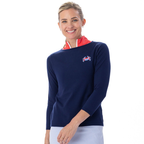 Woman wearing a navy sweater with a small logo on a white background