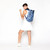 woman wearing a navy and blue shibori pattern pickleball backpack