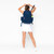 Woman stands on white background wearing navy tennis backpack.