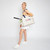 Woman stands on white background with a love all court bag on one of her shoulders. Front view of love all court bag. Canvas tennis tote with side pockets holding water bottle and tennis balls. Front of bag reads the word love, with the letter O made out of a hot pink tennis ball.