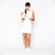 Woman holds white everyday pouch with lime green zipper. Pouch has lime tennis ball with the word love in cursive printed on the front.
