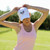 Front view of white baseball hat with navy crossed racquets embroidered on front