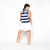 woman wearing navy and white striped pickleball backpack