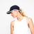 woman wears navy sport hat with white trim