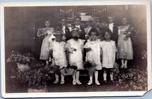 Flower girls and ring bearers in front of organ at wedding AZO 1918-1930