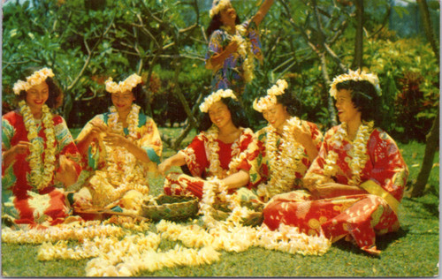 Group of women stringing leis
