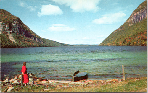 Woman standing near boat at Lake Willoughby