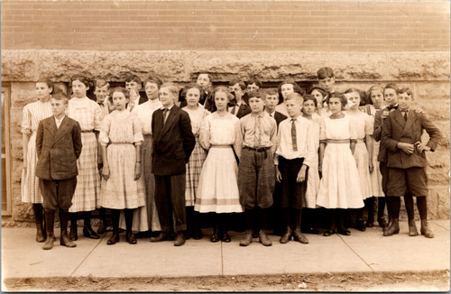 Class Group photo outside against brick stone wall