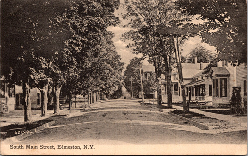 1911 postcard of South Main Street Edmeston NY showing tree-lined dirt road and residential houses published by H. Carman Co. Oneonta printed in Great Britain