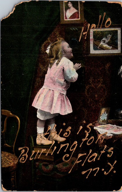 Hand-tinted postcard of a little girl standing on books peering over a table, with gold text reading Hello This is Burlington Flats N.Y