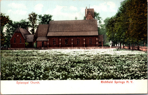 Postcard showing Episcopal Church in Richfield Springs New York wooden Gothic-style church with tall steeple and meadow of flowers.