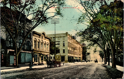 Main Street Herkimer New York early 1900s street scene with storefronts and a horse drawn wagon