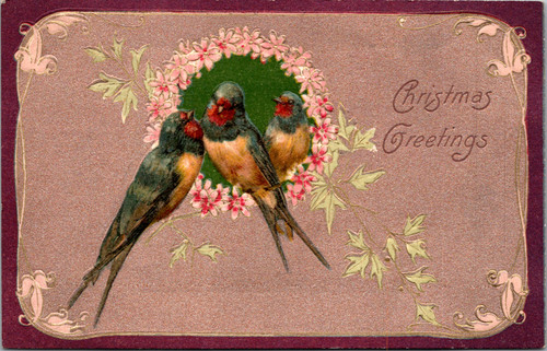Three barn swallows perched around a pink floral wreath on an embossed vintage Christmas postcard