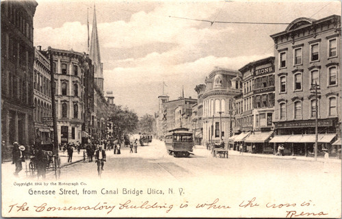 Early postcard of Genesee Street from the Canal Bridge in Utica New York with trolley horse drawn wagons pedestrians and ornate buildings published by Rotograph Co