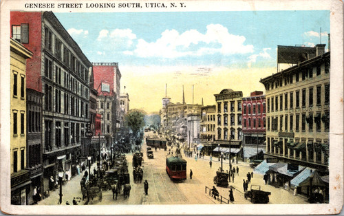 Tinted postcard showing Genesee Street looking south in Utica New York with trolley autos pedestrians and multi story commercial buildings