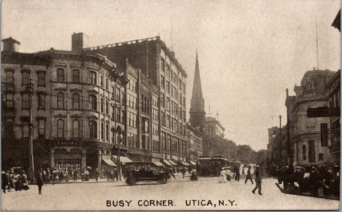 Busy Corner street scene in Utica New York showing buildings, pedestrians, and trolley on Genesee Street.