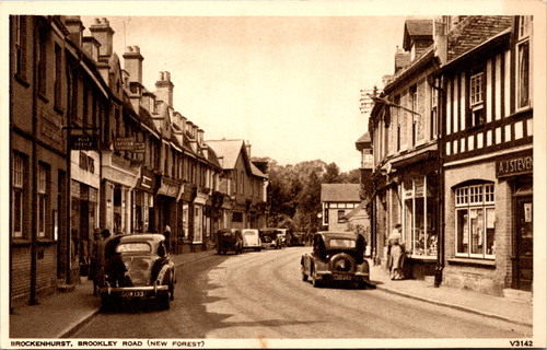Vintage postcard of Brookley Road Brockenhurst New Forest England showing shops and early automobiles