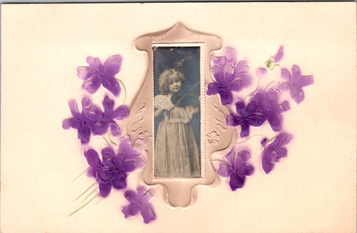 Antique RPPC postcard of a young girl playing a violin set in an embossed floral frame with blue flowers
