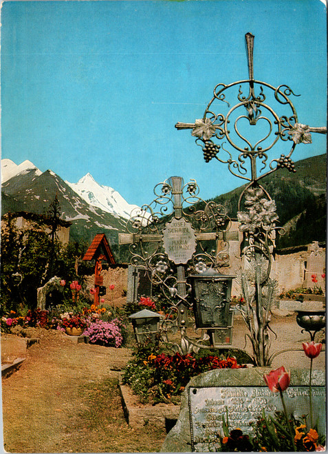 Vintage postcard showing the Bergfriedhof cemetery in Heiligenblut Austria with Großglockner mountain