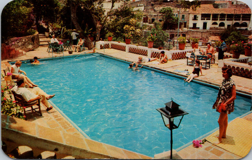 Vintage postcard of Hotel Rancho Telva swimming pool in Taxco Mexico with guests and hillside view