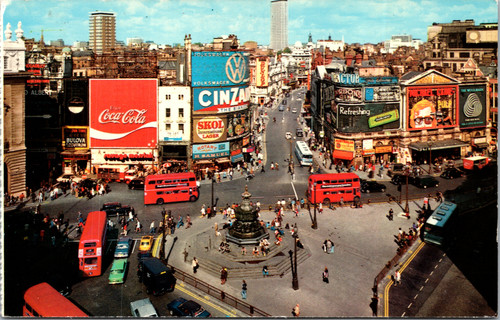 Piccadilly Circus London with Eros statue red buses and vintage advertising signs