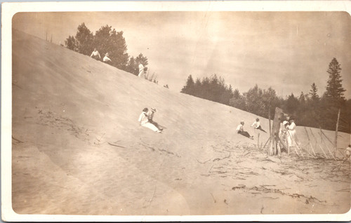 Vintage RPPC boy fishing under wooden bridge pier early 1900s