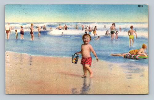 vintage linen postcard beach scene child in surf with pail