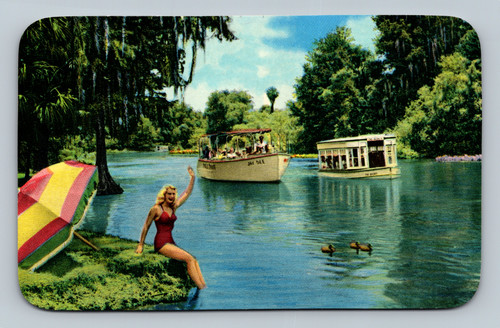 Scene on Silver River at Florida's Silver Springs with Jungle Cruise and glass bottom boats