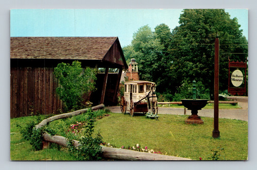 Milk wagon and watering trough by covered bridge entrance at Shelburne Museum Vermont