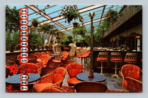 The Greenhouse with plants, glass roof, and flowing water at Holiday Inn Erie PA