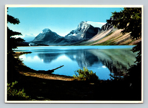 Reflections of Bow Lake with glacier-capped Crowfoot Mountain near Num-ti-jah Lodge Banff
