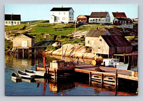 Granite playground and green grass over craggy granite mounds at Peggy's Cove fishing village