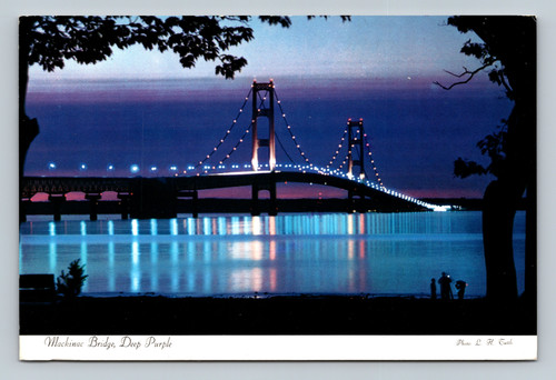 Mackinac Bridge illuminated in deep purple lights at night
