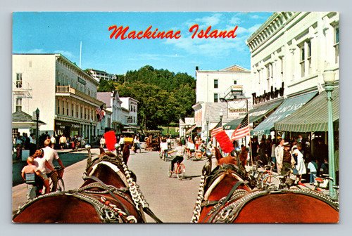 Typical street scene on Mackinac Island with horses and carriages
