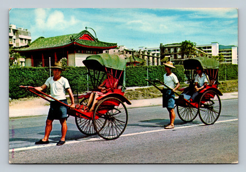 Pleasure rides on rickshaws in Hong Kong city street scene