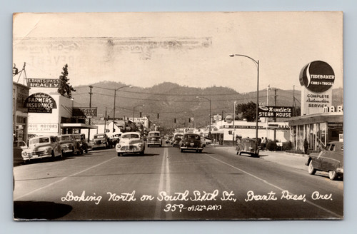 Looking north on South Sixth Street with businesses and automotive services in Grants Pass Oregon
