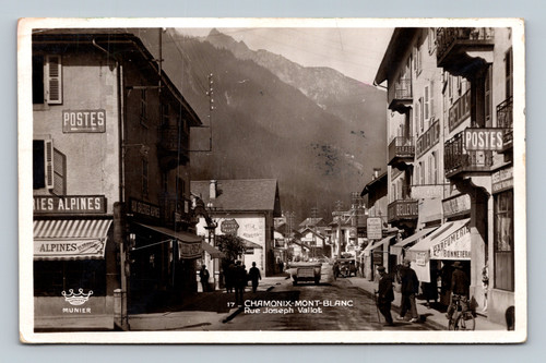 Street scene with garage, perfumerie, alpine shops, and Savoy Palace entrance in Chamonix-Mont-Blanc