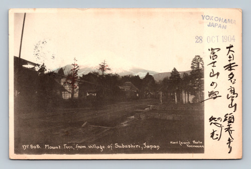 Early 1904 Karl Lewis photographic postcard showing Mount Fuji rising behind the village of Subashiri, Japan, with handwritten Japanese text and Yokohama October 28 1904 marking.