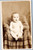 Baby in diaper sitting in chair - AZO 1904-1918