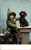 Boy in Green Coat sitting with dachsund in snow Boy in Green Coat sitting with dachsund in snow