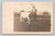 Farmer standing with cow RPPC